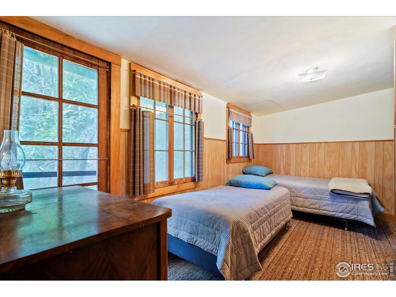 49 Riverside Drive Lyons, CO 80540 - Photo 23 of 32 a bedroom with a bed and a large window