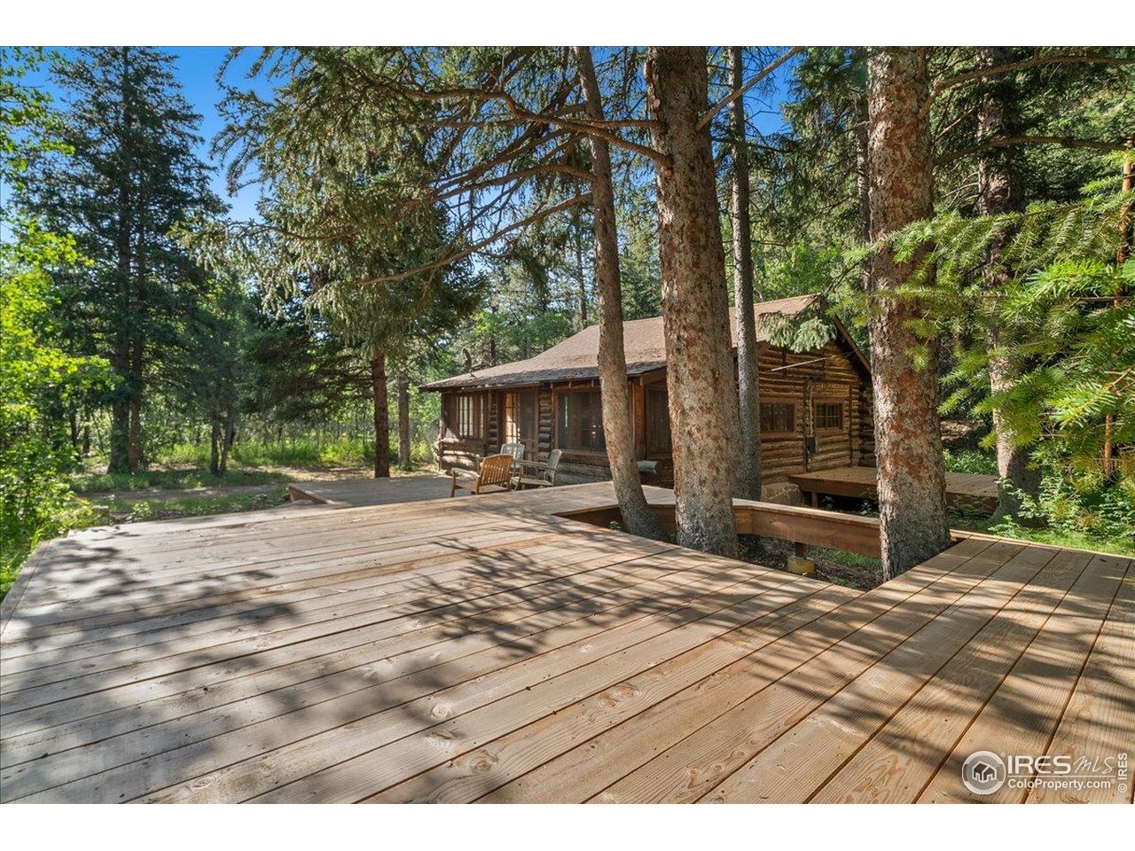 49 Riverside Drive Lyons, CO 80540 - Photo 25 of 32 a view of a house with backyard and sitting area