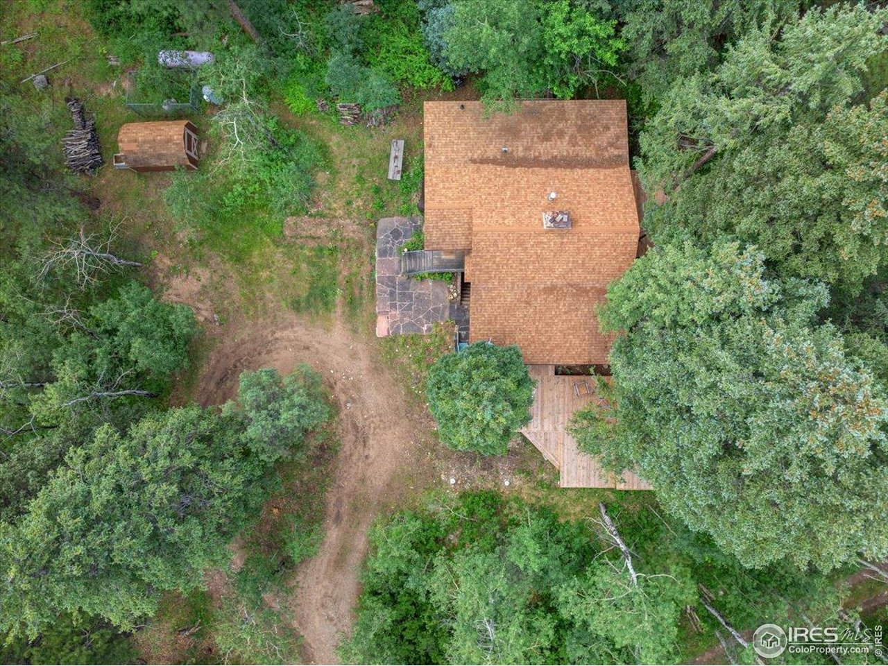 49 Riverside Drive Lyons, CO 80540 - Photo 30 of 32 an aerial view of a house with a yard and trees all around