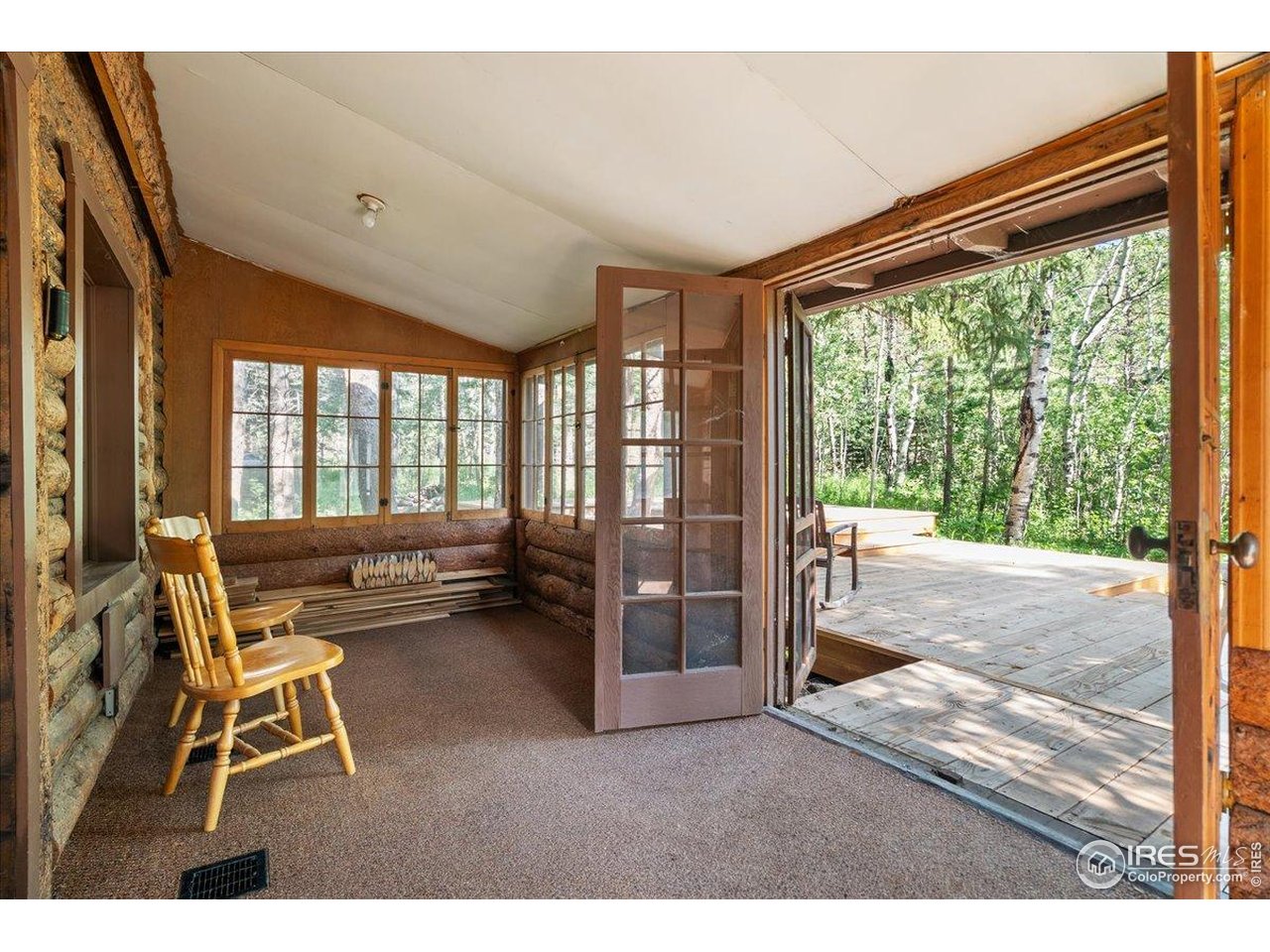 49 Riverside Drive Lyons, CO 80540 - Photo 5 of 32 a living room with furniture and a large window