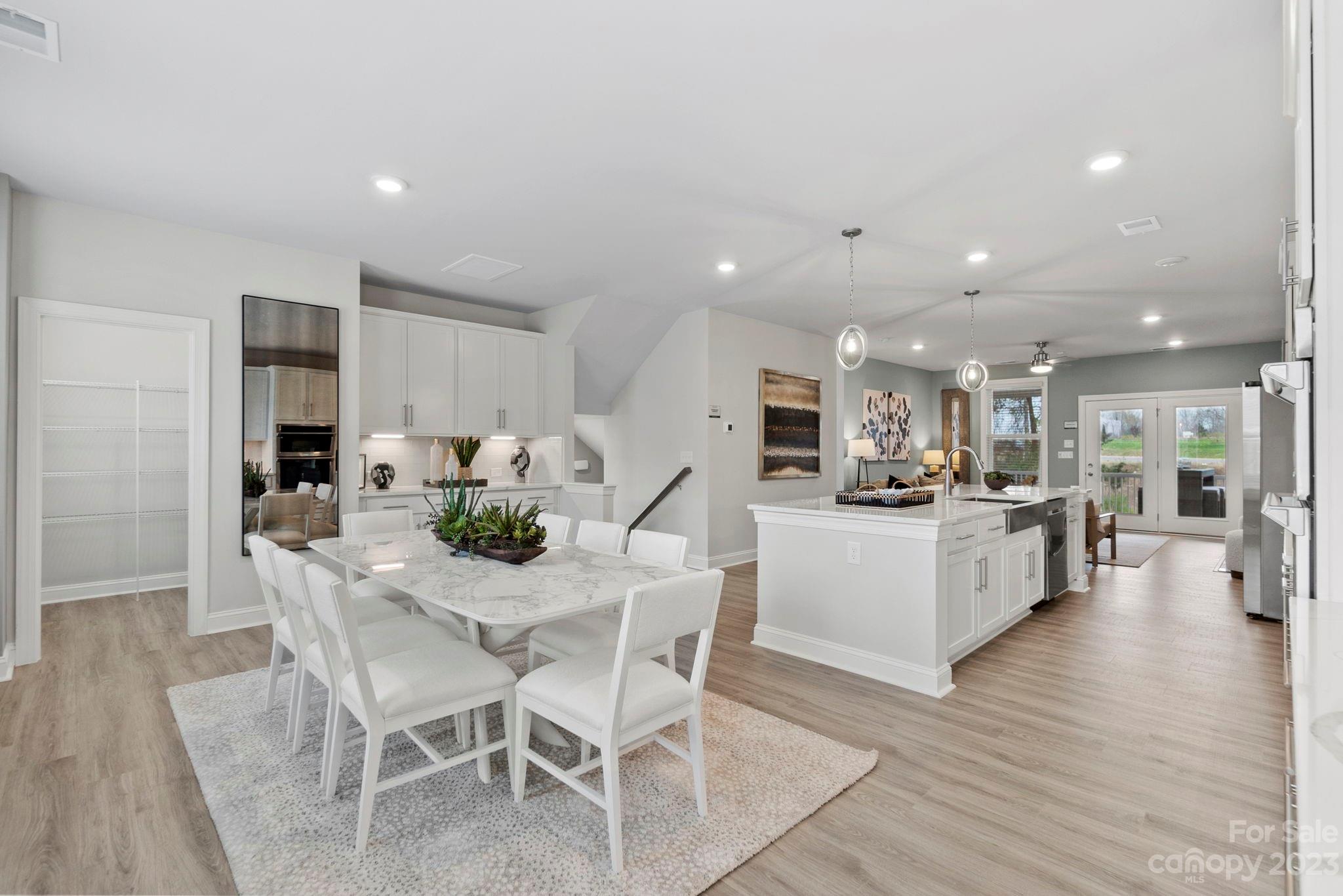 4505 Forsyth Place Fort Mill, SC 29708 - Photo 1 of 23 a kitchen with stainless steel appliances kitchen island granite countertop a table chairs and a refrigerator