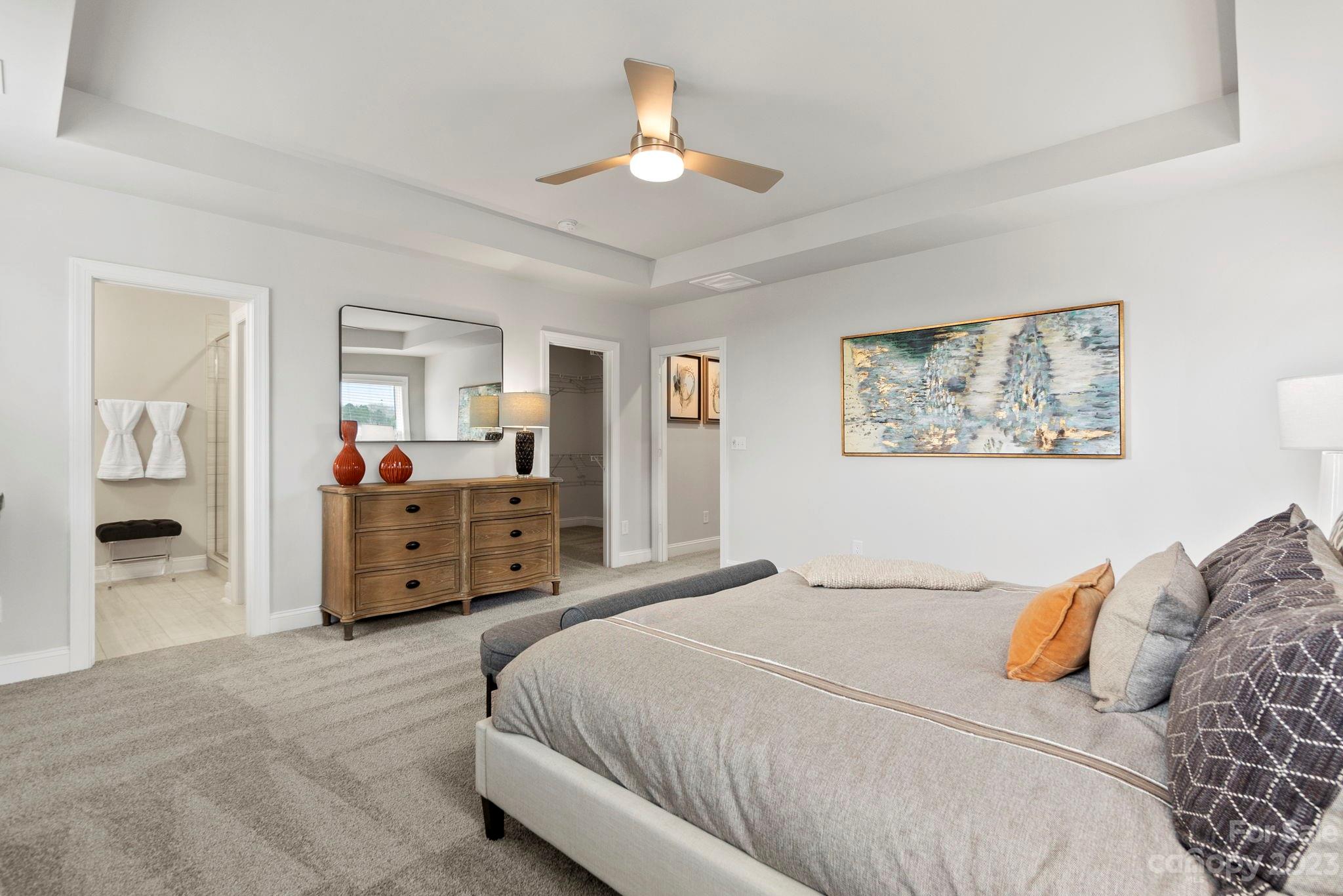 4505 Forsyth Place Fort Mill, SC 29708 - Photo 16 of 23 a spacious bedroom with a bed a dresser and mirror