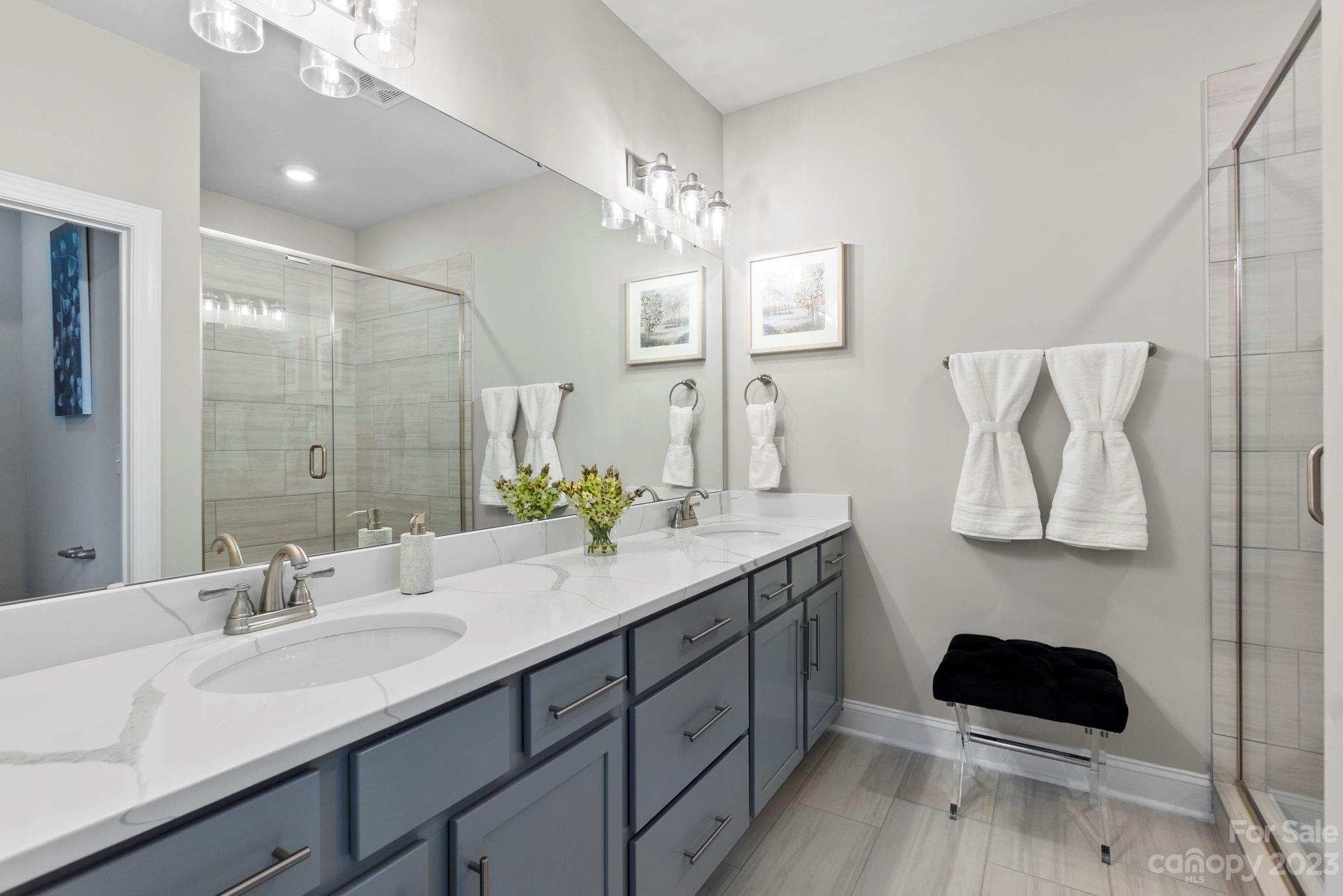 4505 Forsyth Place Fort Mill, SC 29708 - Photo 17 of 23 a bathroom with a double vanity sink and a mirror