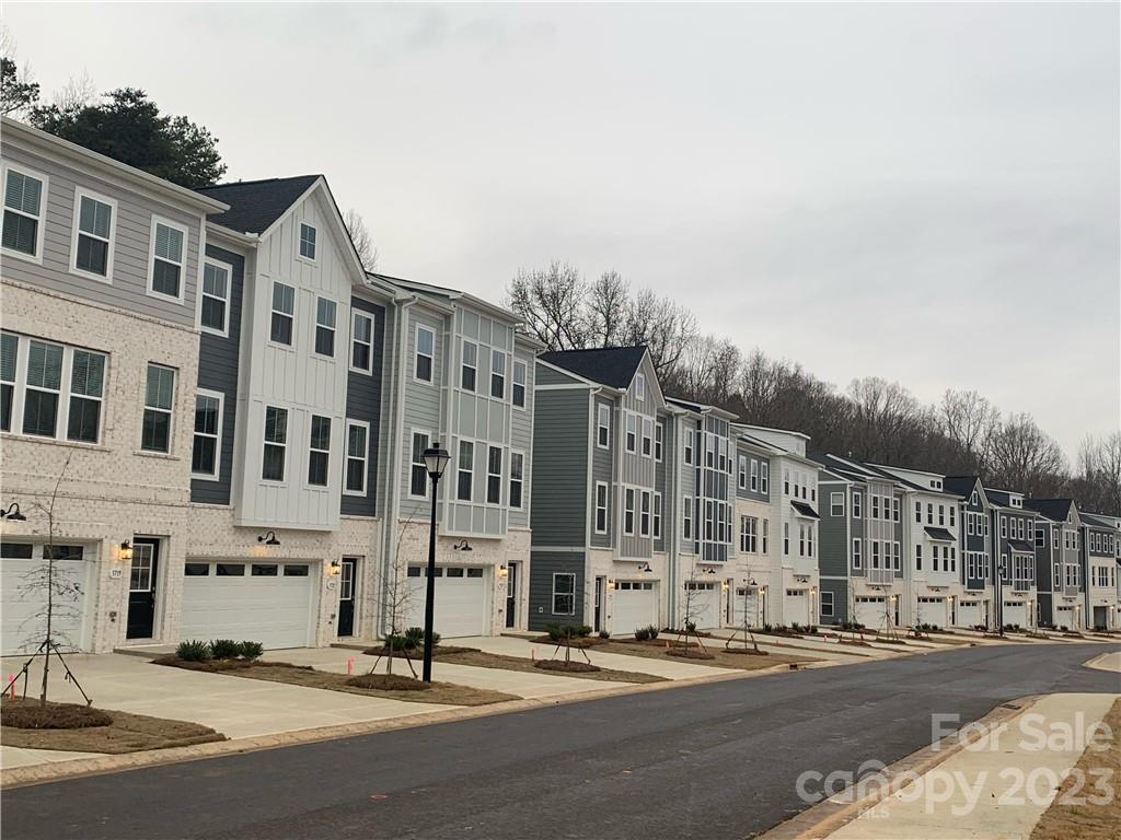 4505 Forsyth Place Fort Mill, SC 29708 - Photo 2 of 23 a city street lined with buildings and trees