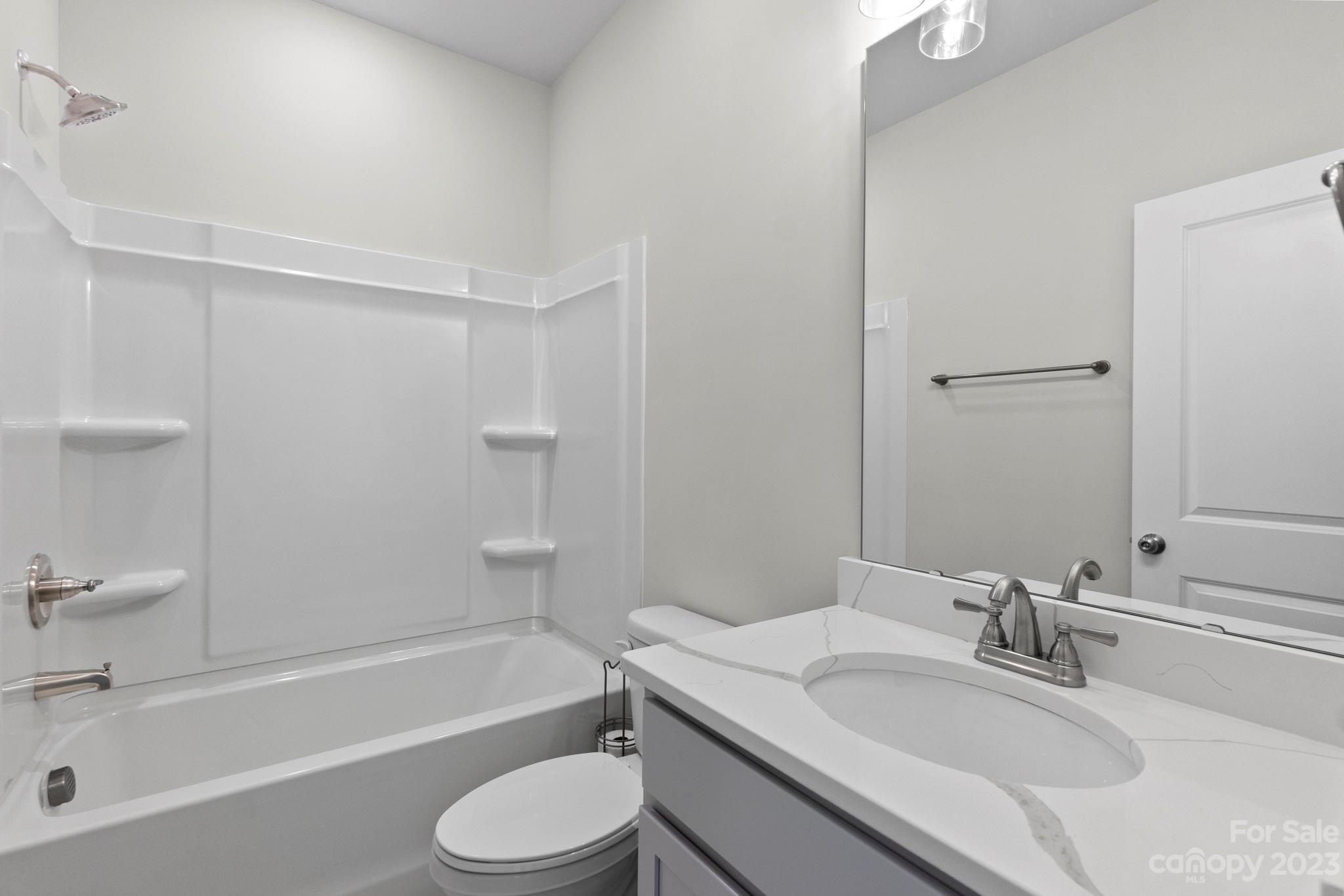 4505 Forsyth Place Fort Mill, SC 29708 - Photo 22 of 23 a bathroom with a granite countertop sink toilet tub and shower