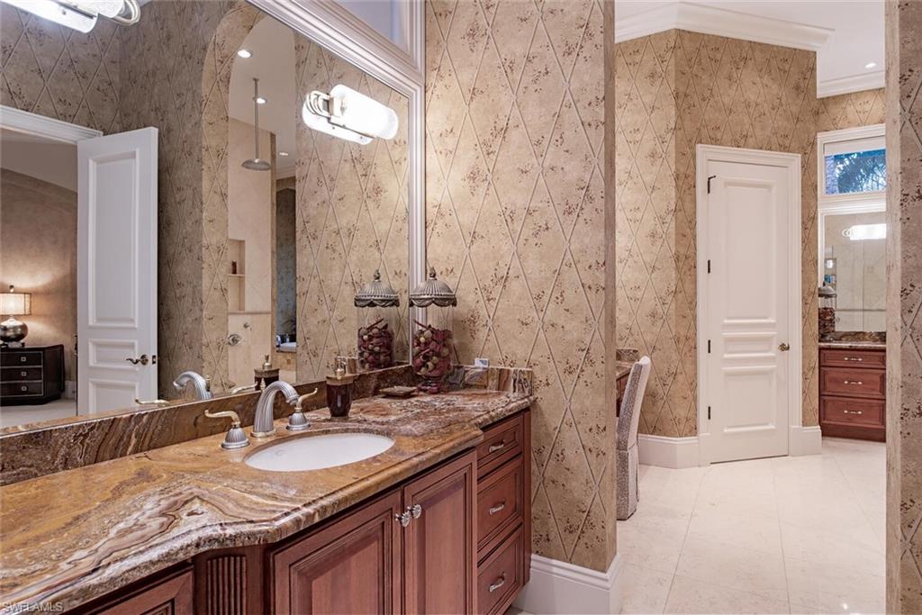 14919 Celle Way Naples, FL 34110 - Photo 11 of 42 a bathroom with a granite countertop sink and a mirror