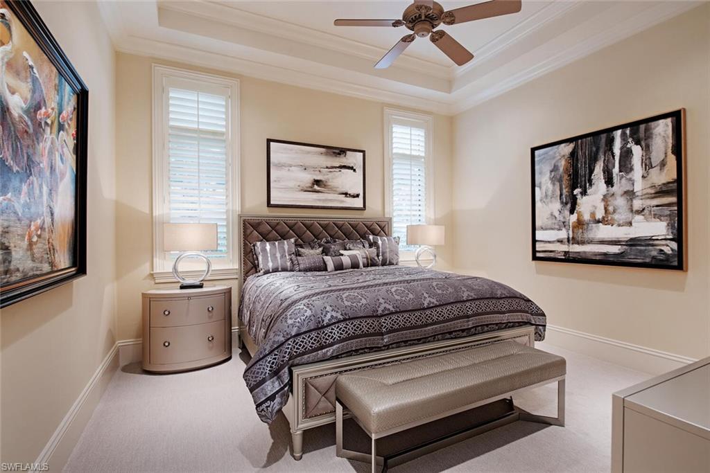 14919 Celle Way Naples, FL 34110 - Photo 12 of 42 a bedroom with a bed and a painting on the wall