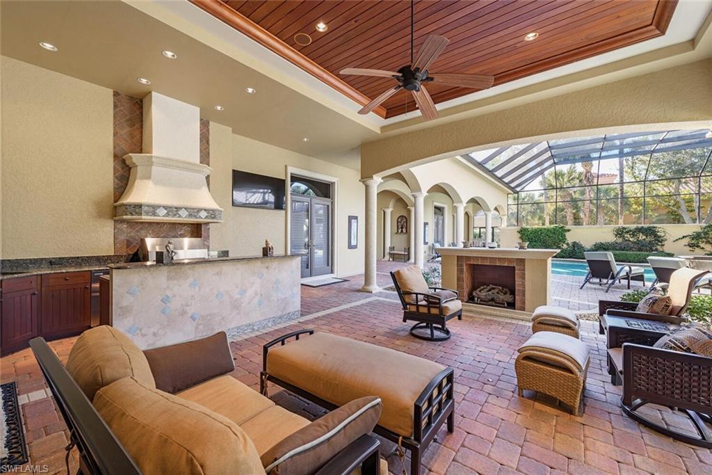 14919 Celle Way Naples, FL 34110 - Photo 16 of 42 a living room with furniture fireplace and a view of kitchen