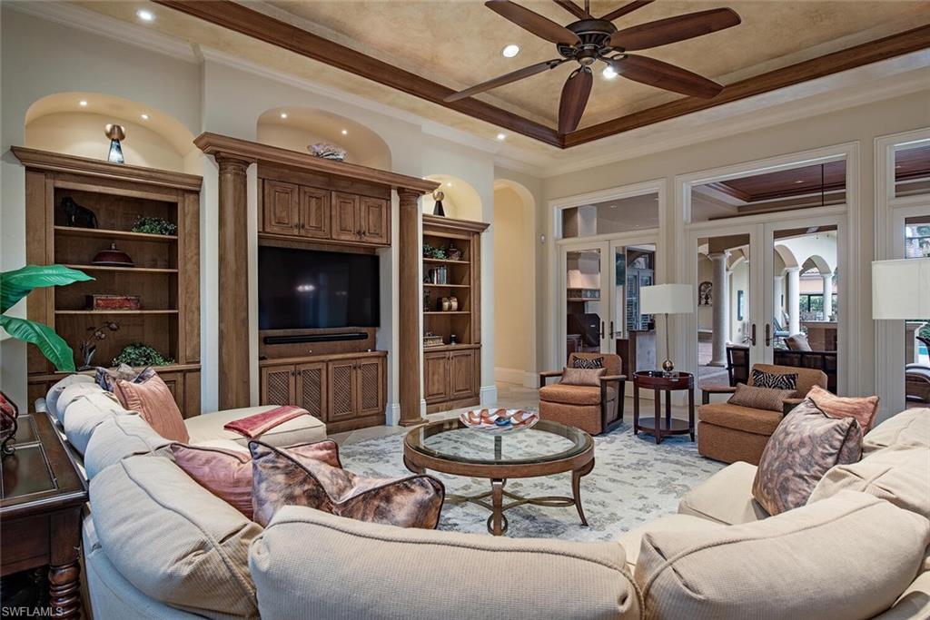 14919 Celle Way Naples, FL 34110 - Photo 4 of 42 a living room with furniture and a flat screen tv