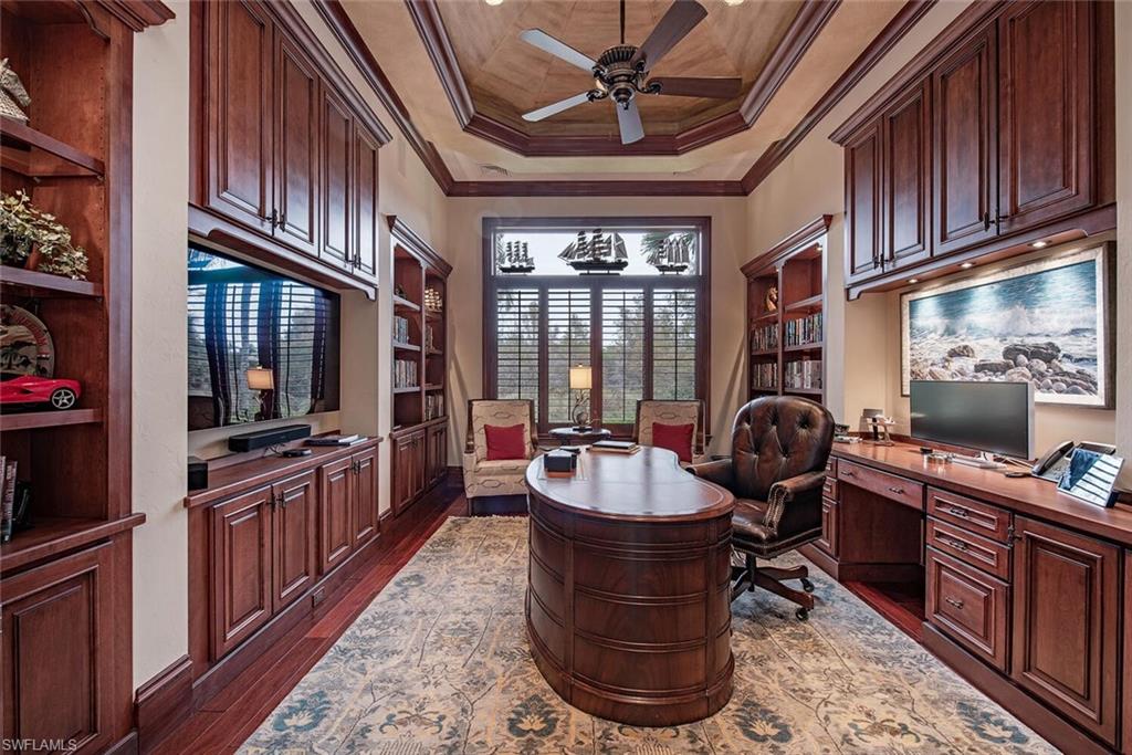 14919 Celle Way Naples, FL 34110 - Photo 7 of 42 a living room with fireplace furniture and a flat screen tv