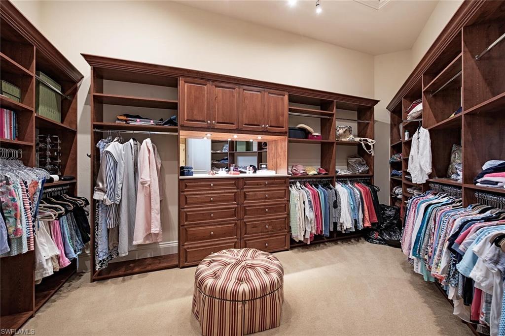 14919 Celle Way Naples, FL 34110 - Photo 9 of 42 a view of walk in closet with clothes and shoes