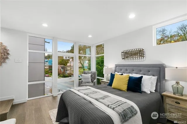 a bedroom with a bed and a large window