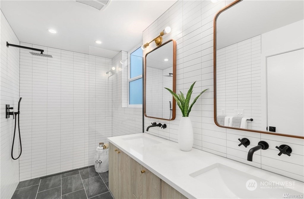 2408 Dexter Avenue North, Unit B Seattle, WA 98109 - Photo 9 of 11 a bathroom with a sink and a mirror