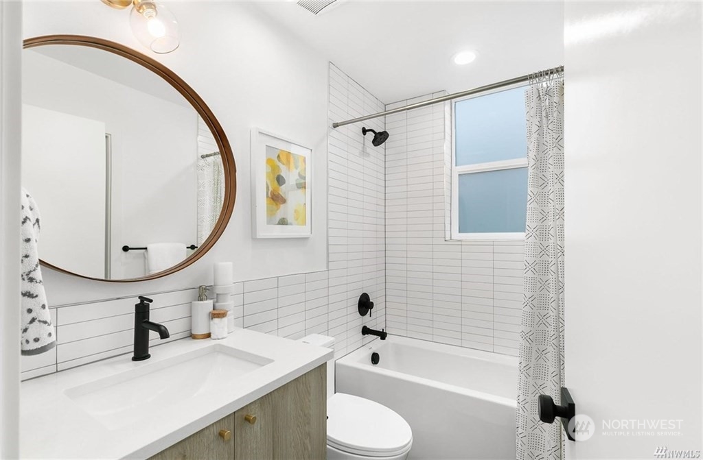 2408 Dexter Avenue North, Unit B Seattle, WA 98109 - Photo 10 of 11 a bathroom with a sink toilet and shower