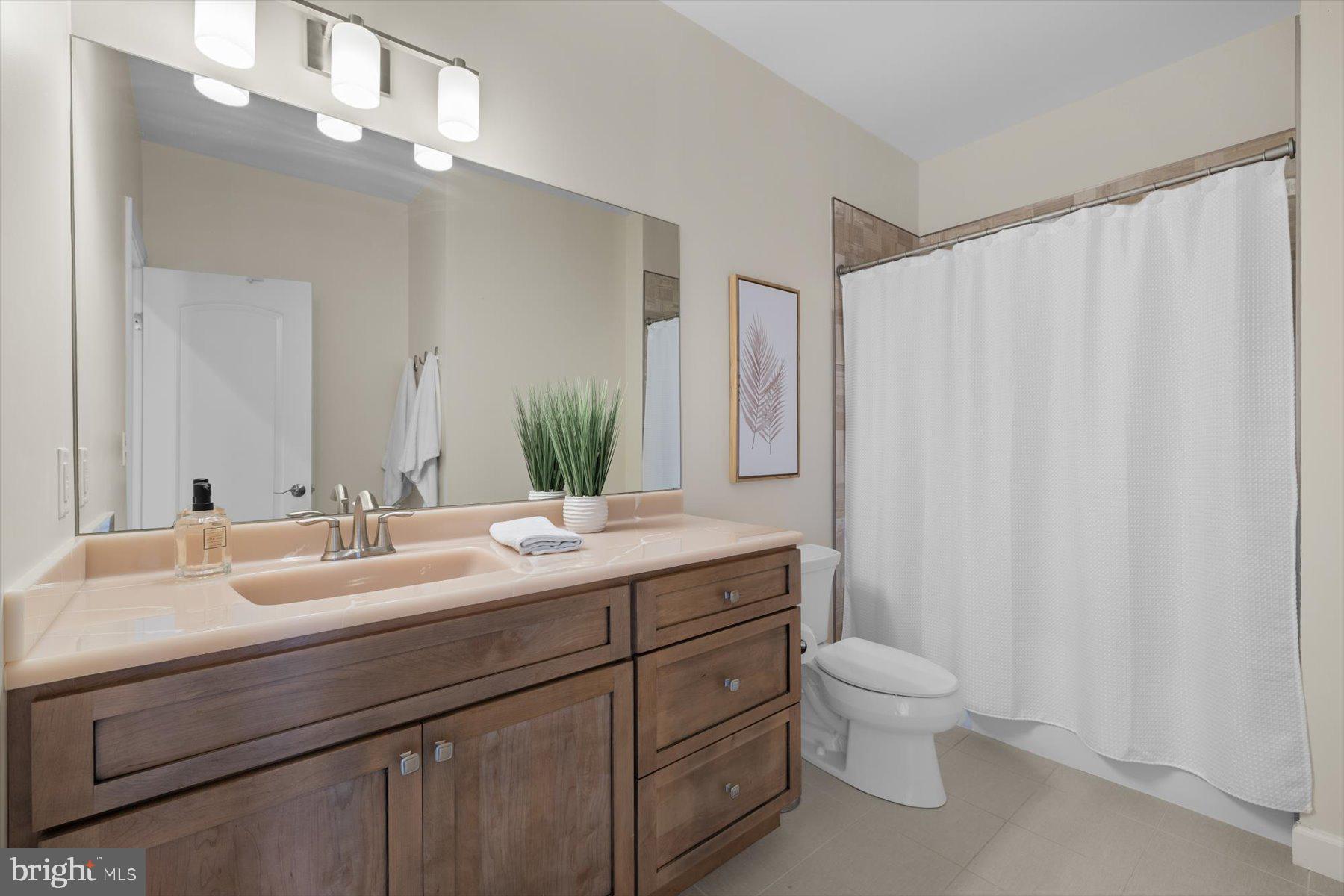 35 Inlet View Court Bethany Beach, DE 19930 - Photo 49 of 74 a bathroom with a double vanity sink toilet and a mirror