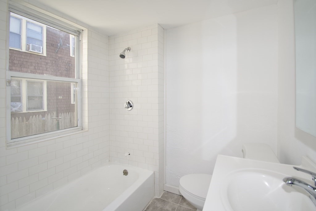 79 Quincy Street Springfield, MA 01109 - Photo 14 of 27 a bathroom with a bathtub and a toilet
