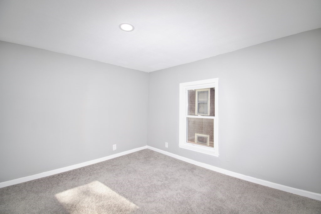 79 Quincy Street Springfield, MA 01109 - Photo 22 of 27 a view of an empty room with a window