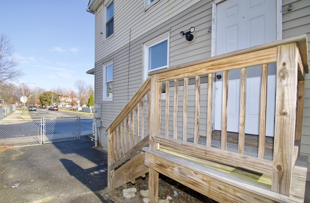 79 Quincy Street Springfield, MA 01109 - Photo 26 of 27 a view of a balcony with wooden floor and fence