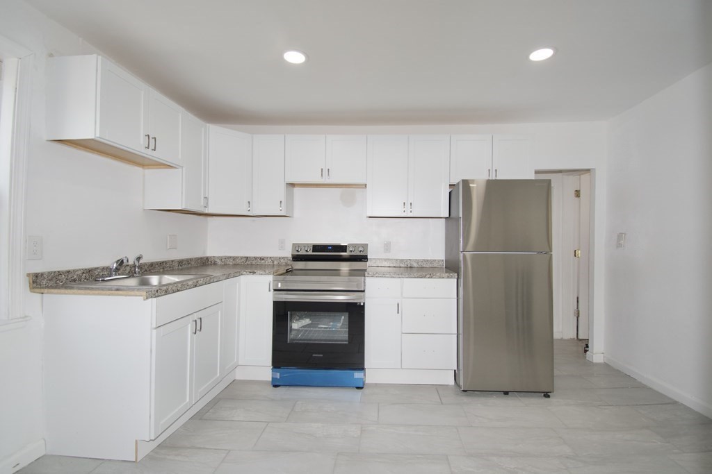 79 Quincy Street Springfield, MA 01109 - Photo 5 of 27 a kitchen with a refrigerator sink and cabinets