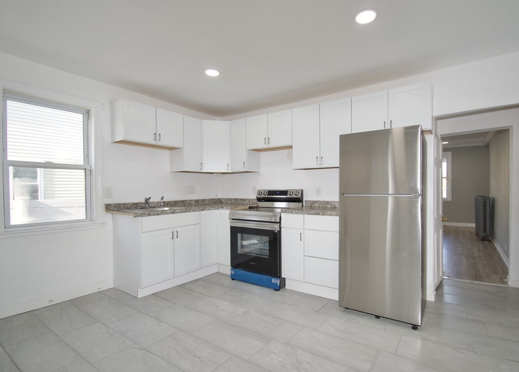 79 Quincy Street Springfield, MA 01109 - Photo 7 of 27 a kitchen with a refrigerator sink and cabinets
