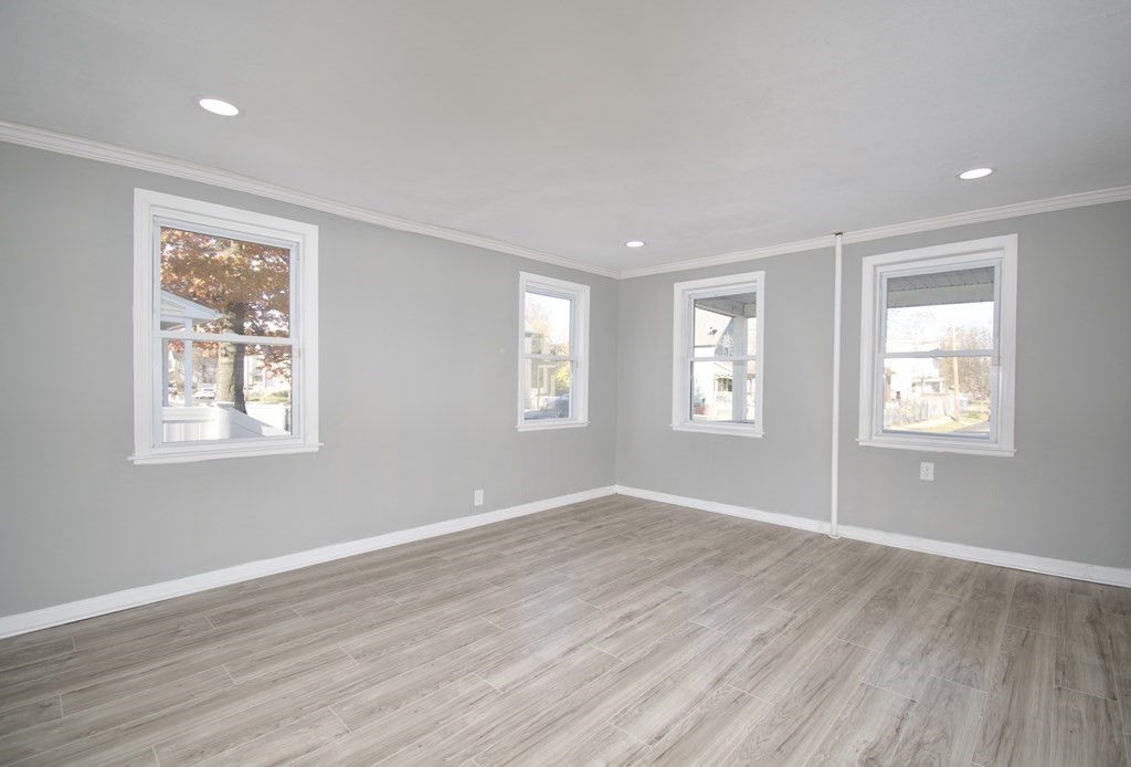 79 Quincy Street Springfield, MA 01109 - Photo 8 of 27 a view of an empty room with wooden floor and a window