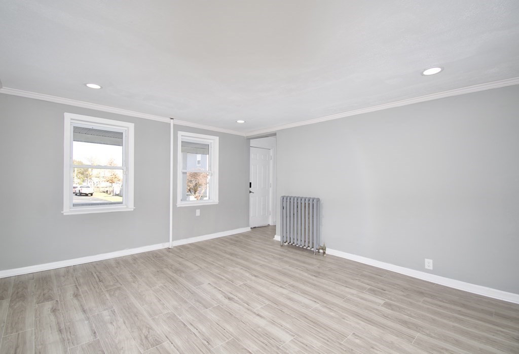 79 Quincy Street Springfield, MA 01109 - Photo 9 of 27 an empty room with wooden floor and windows