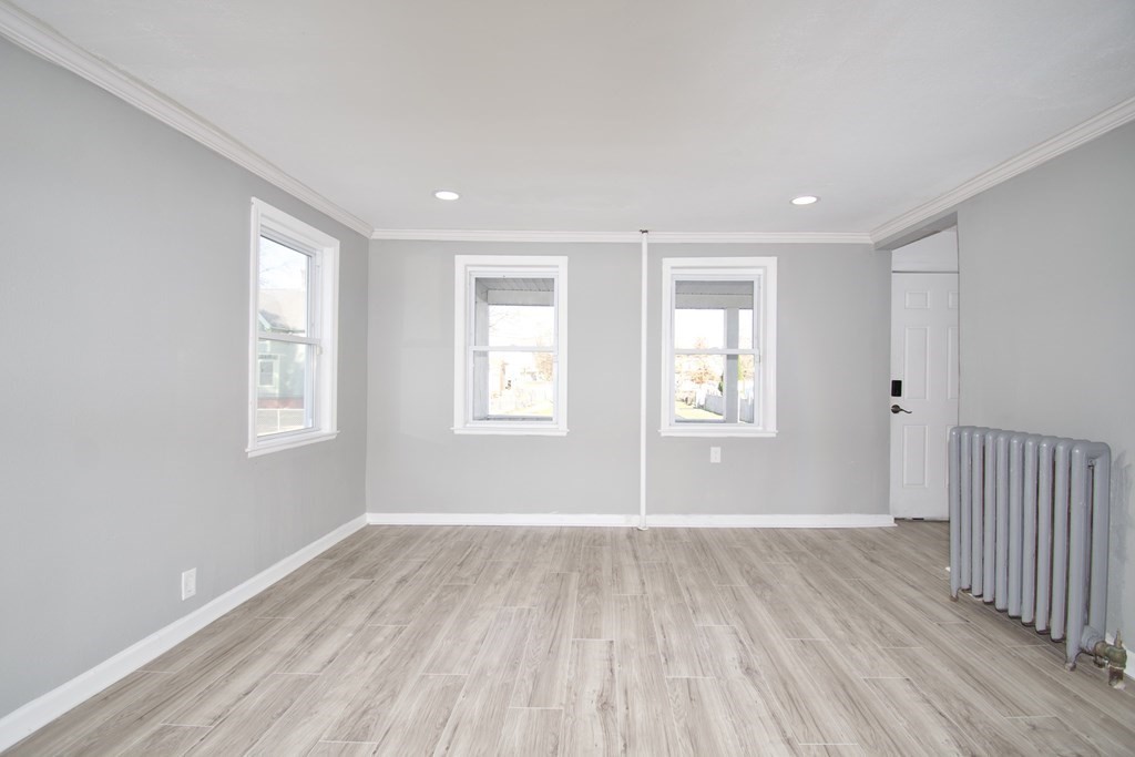 79 Quincy Street Springfield, MA 01109 - Photo 10 of 27 a view of a room with wooden floor and windows
