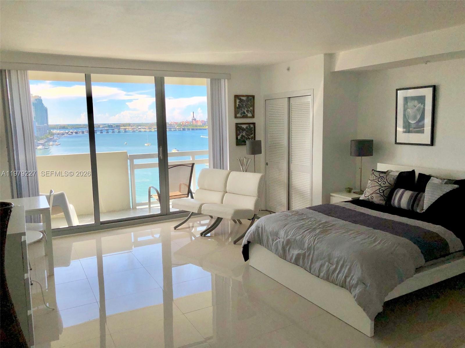 1500 Bay Road, Unit 1236S Miami Beach, FL 33139 - Photo 2 of 24 a spacious bedroom with a large bed and a large window