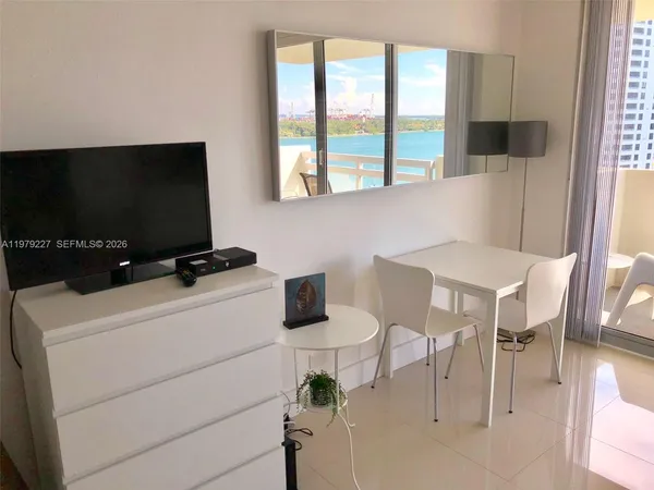 a view of a livingroom with furniture and a flat screen tv
