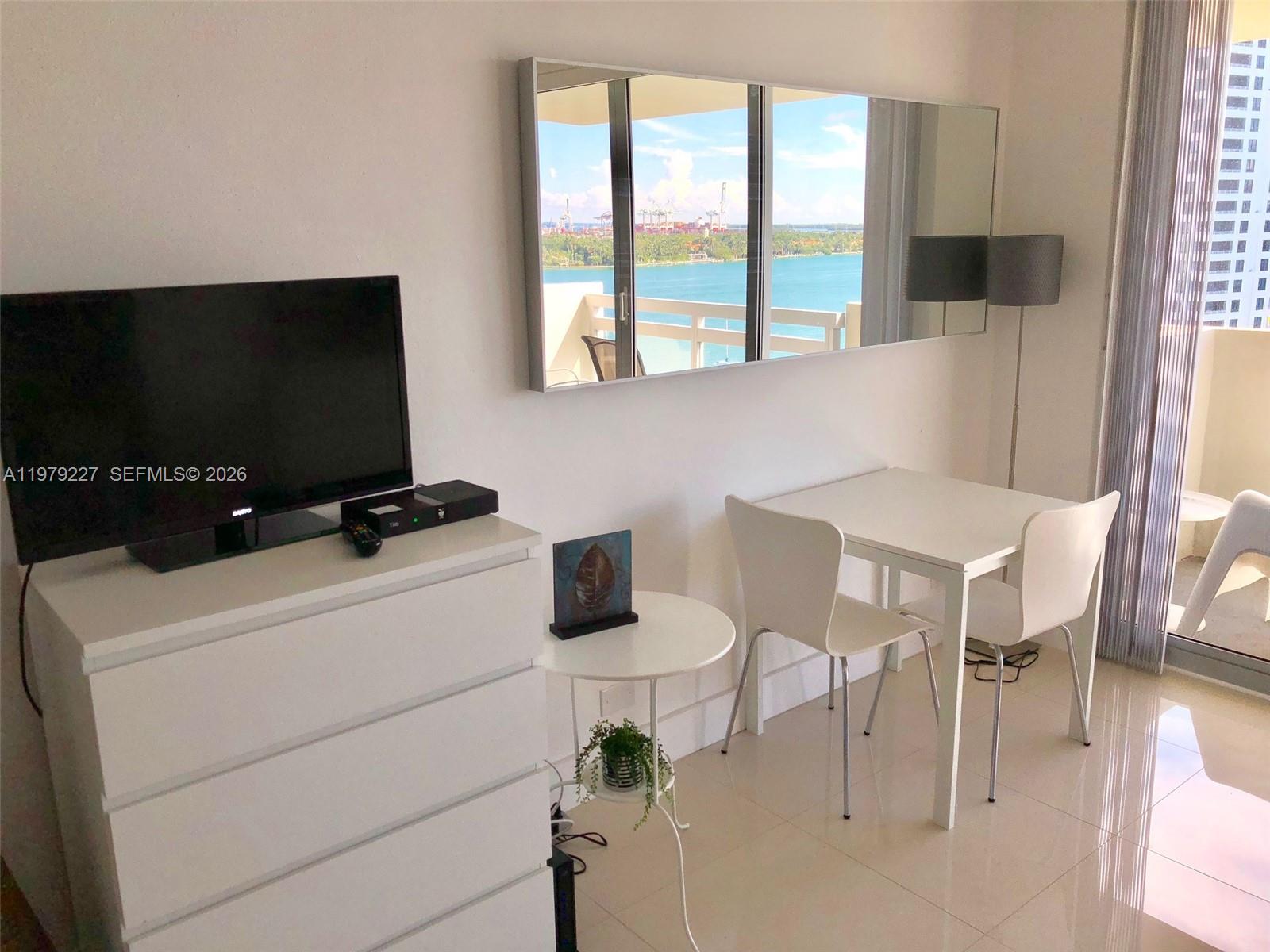 1500 Bay Road, Unit 1236S Miami Beach, FL 33139 - Photo 10 of 24 a view of a livingroom with furniture and a flat screen tv