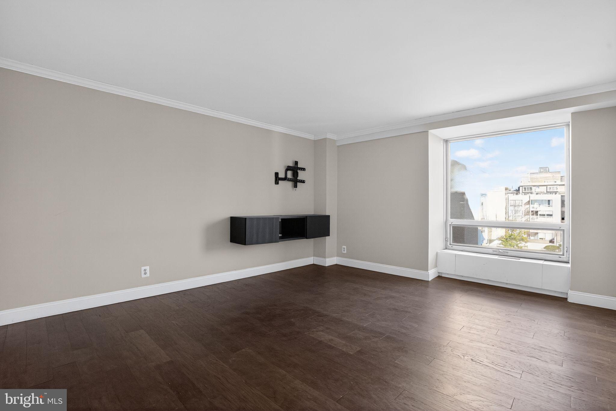 1435 4th Street Southwest, Unit B201 Washington, DC 20024 - Photo 2 of 13 an empty room with wooden floor and windows