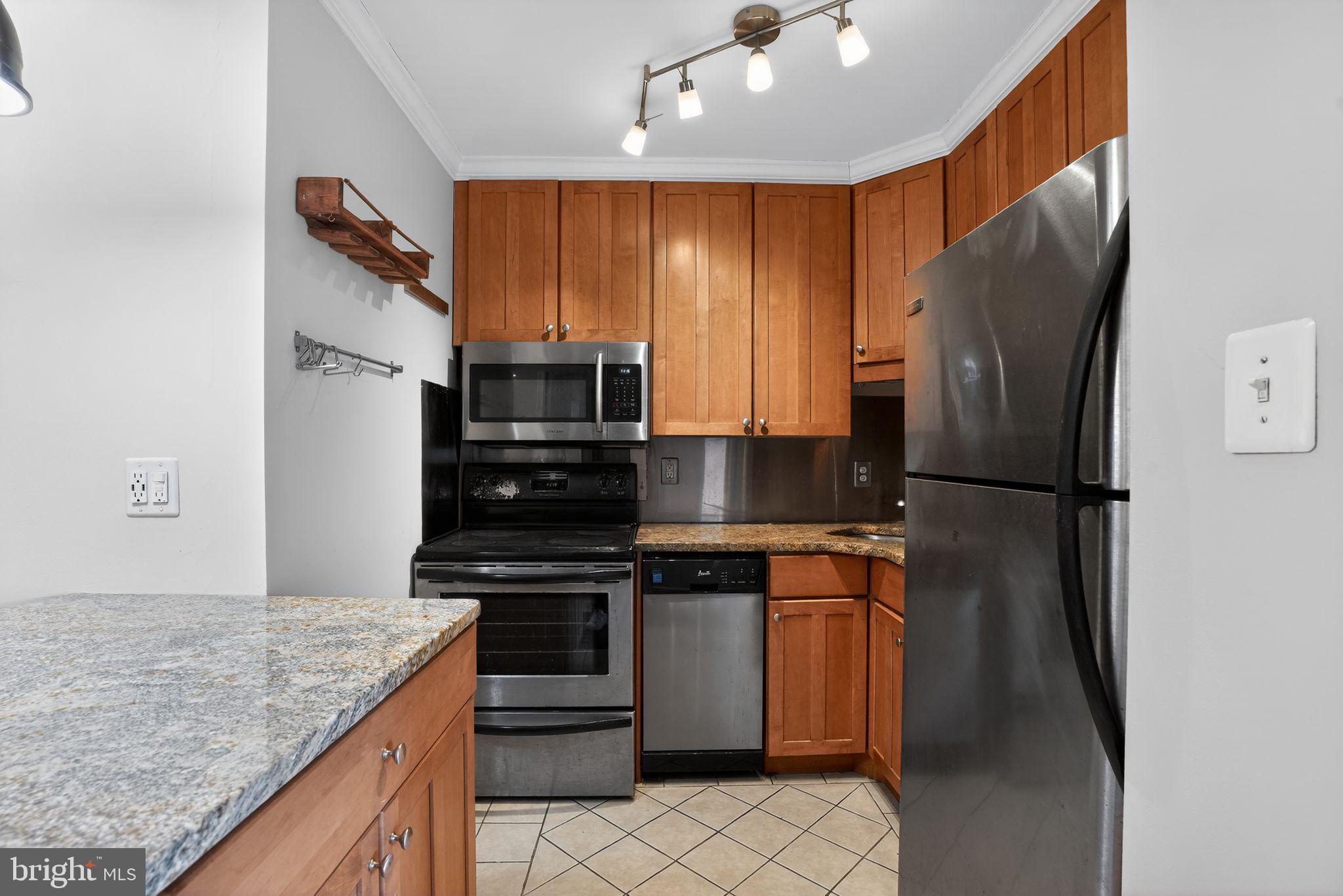 1435 4th Street Southwest, Unit B201 Washington, DC 20024 - Photo 5 of 13 a kitchen with stainless steel appliances granite countertop a refrigerator stove and microwave