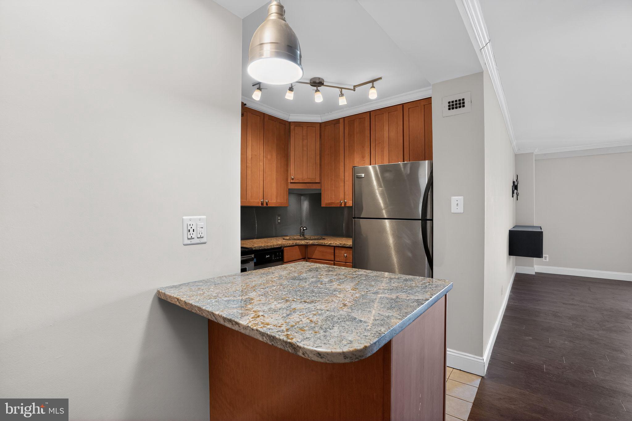 1435 4th Street Southwest, Unit B201 Washington, DC 20024 - Photo 6 of 13 a kitchen with stainless steel appliances granite countertop a sink refrigerator and microwave
