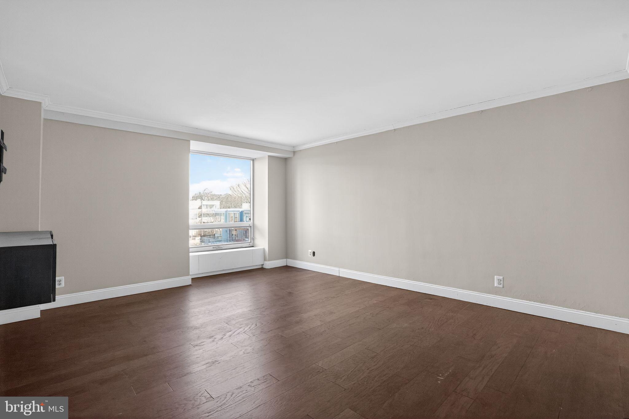 1435 4th Street Southwest, Unit B201 Washington, DC 20024 - Photo 9 of 13 a view of an empty room with wooden floor and a window