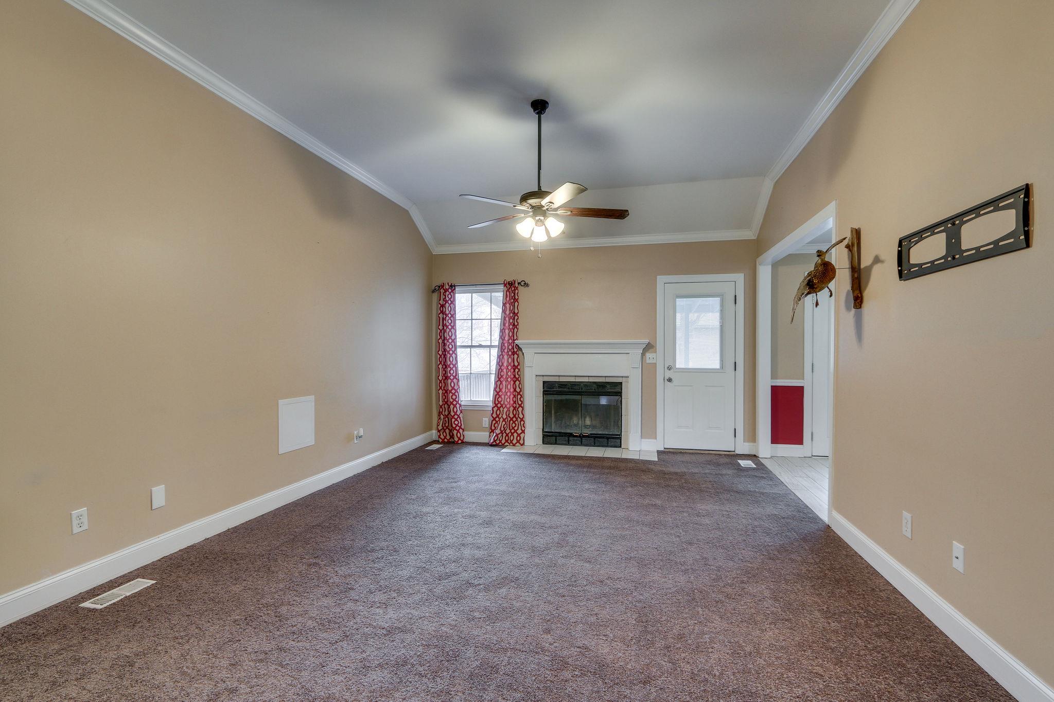 1056 Fitzpatrick Road Nashville, TN 37214 - Photo 6 of 28 Living room with fireplace, ceiling fan and NEW carpet