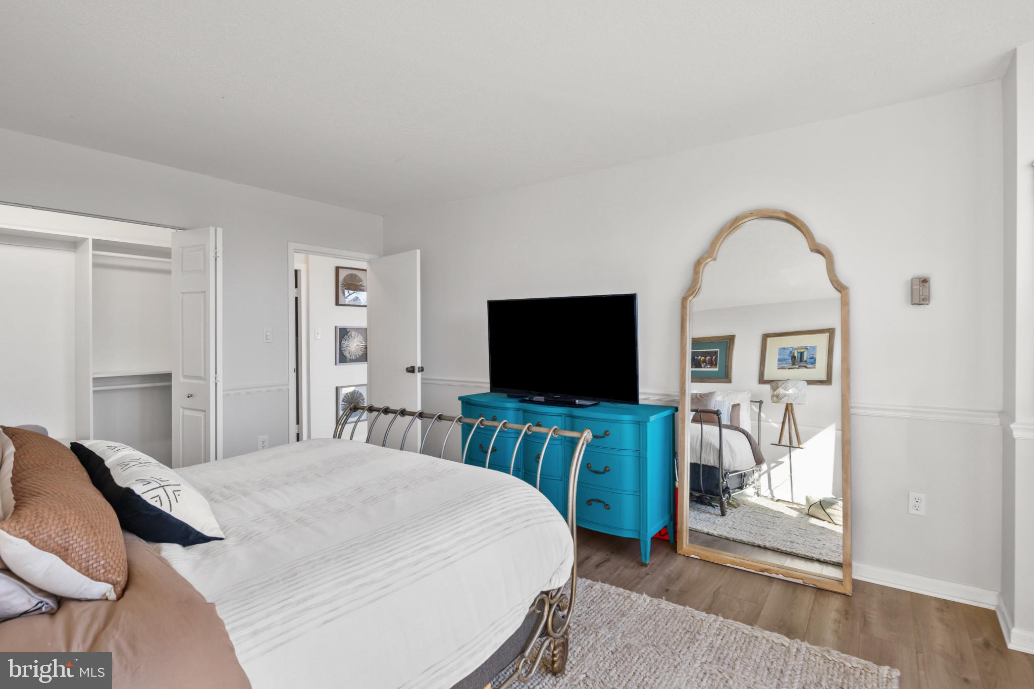 4401 Roland Avenue, Unit 310 Baltimore, MD 21210 - Photo 19 of 24 a bedroom with a bed and a flat screen tv