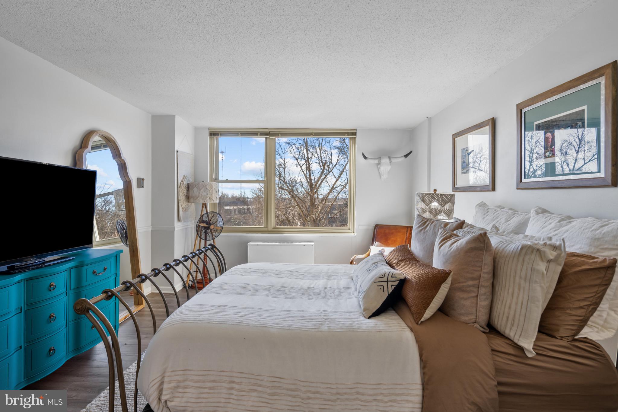4401 Roland Avenue, Unit 310 Baltimore, MD 21210 - Photo 20 of 24 a bedroom with furniture and a flat screen tv