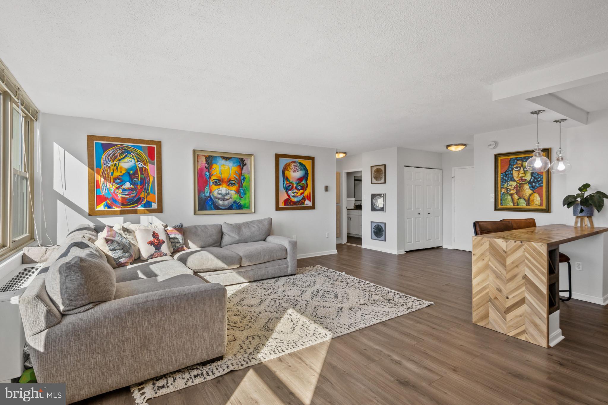 4401 Roland Avenue, Unit 310 Baltimore, MD 21210 - Photo 10 of 24 a living room with furniture and a flat screen tv