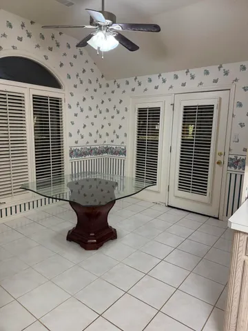 a white toilet sitting next to a shower