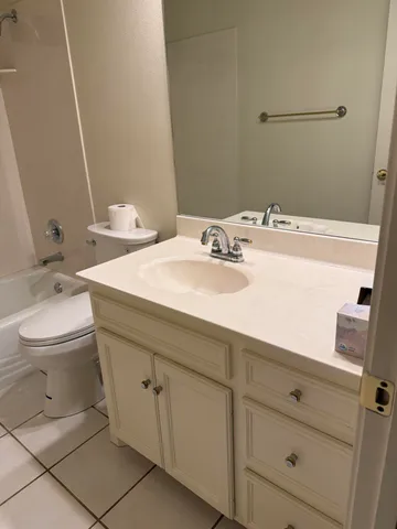 a bathroom with a toilet a sink and bathtub