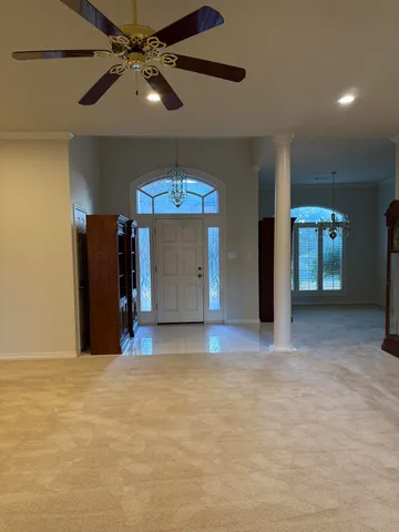 a view of an empty room with a ceiling fan