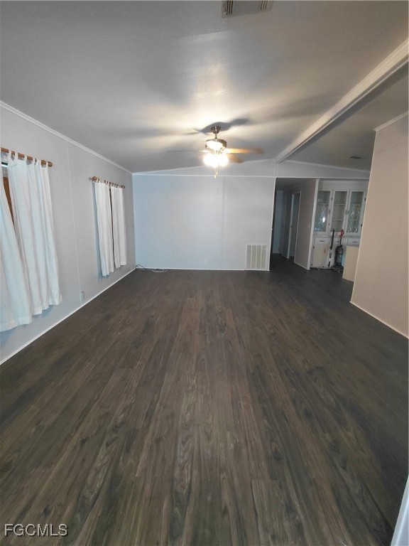 708 Bowden Road Clewiston, FL 33440 - Photo 22 of 44 an empty room with wooden floor chandelier fan and windows