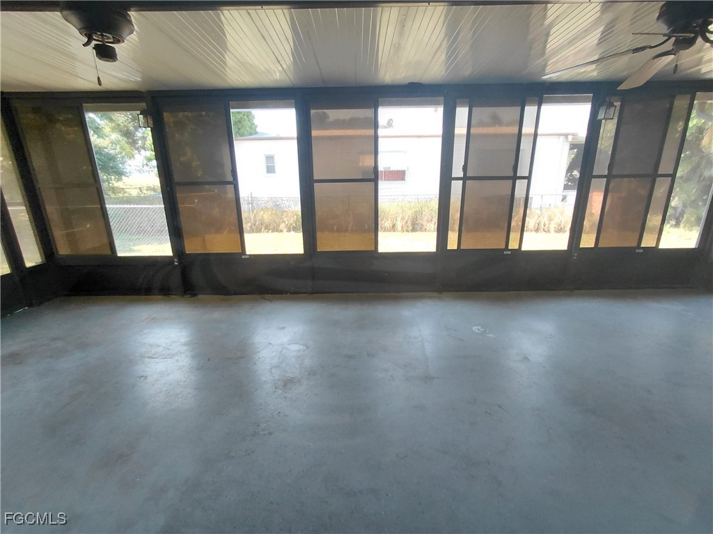 708 Bowden Road Clewiston, FL 33440 - Photo 29 of 44 an empty room with wooden floor and windows