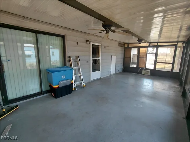 a utility room with granite countertop cabinets washer and dryer