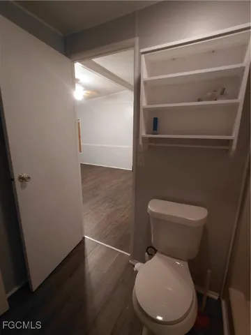 a white toilet sitting next to a bathroom sink and a shower