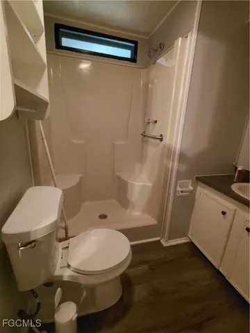 a bathroom with a toilet and a shower