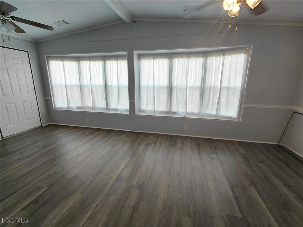 708 Bowden Road Clewiston, FL 33440 - Photo 7 of 44 a view of an empty room with wooden floor and a window