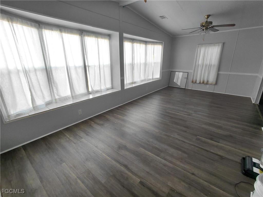 708 Bowden Road Clewiston, FL 33440 - Photo 8 of 44 a view of an empty room with wooden floor and a window