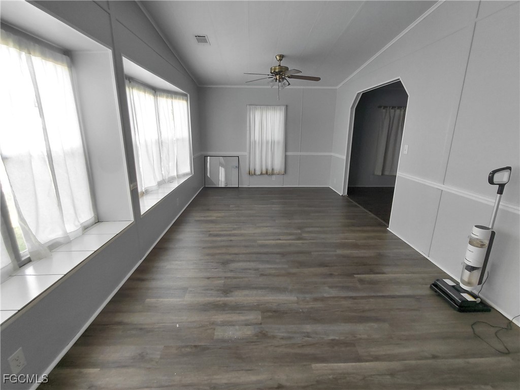 708 Bowden Road Clewiston, FL 33440 - Photo 9 of 44 wooden floor in an empty room with a window