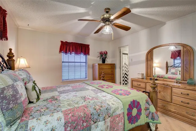 a bedroom with a large bed and a chandelier